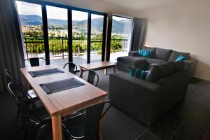 a living room with a couch and a table at New Norfolk Holiday Apartments in New Norfolk