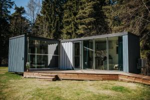 a modular house with glass doors on a field at Üleoja Pesa in Kloogaranna