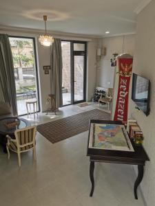a living room with a table and a coke machine at Hostel Rioni in Kutaisi