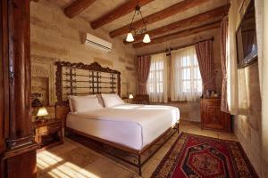 a bedroom with a large white bed in a room at Mithra Cave Cappadocia in Göreme