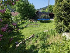 a garden with a playground in the background at Ferienhaus Hilde in Steinwiesen