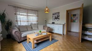 a living room with a couch and a coffee table at Ferienhaus Hilde in Steinwiesen