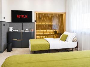 a hotel room with two beds and a sign at Atera Business Suites in Belgrade +69 photos