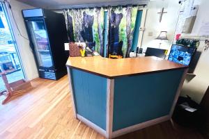 a kitchen with a blue island in a room at Big South Fork Trail Lodge Stearns in Stearns