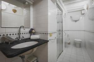 a bathroom with a sink and a toilet at Residenza d'Epoca " Il Campo" by FrancigenaApartments in Siena +102 photos