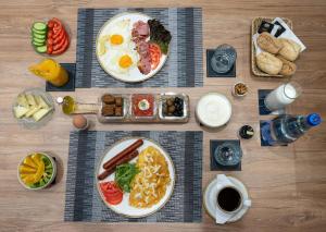 a table topped with plates of breakfast food and coffee at Captain Napoleon Paterakis CNP Luxurious Suites in Heraklio