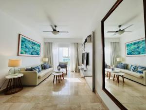 a living room with a couch and a mirror at Cana Rock Infinity Pool & Beach Club in Punta Cana