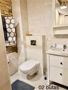 a bathroom with a toilet and a sink at Six Apartment Simona in Vilnius +30 photos