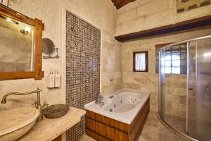 a bathroom with a tub and a sink and a shower at Mithra Cave Cappadocia in Göreme +83 photos