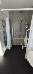 a bathroom with a shower and a sink at Chandler's Lodge B&B in Camelford