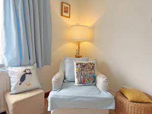 a room with a chair and a lamp and a pillow at Crail House in Crail +14 photos