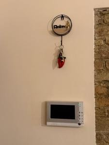 a microwave with a small tv on a wall at La Roccia in Reggio di Calabria