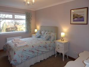 a small bedroom with a bed and a window at Crail House in Crail