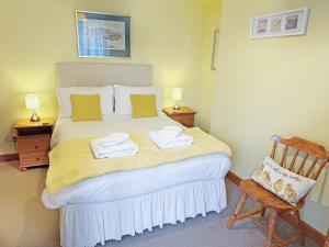 a bedroom with a bed with towels on it at Crail House in Crail