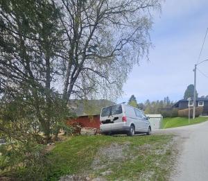 a white van parked on the side of a road at Leilighet med 2 soverom in Storen +7 photos
