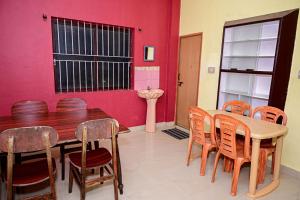 a dining room with a wooden table and chairs at Coorg villa homestay in Madikeri