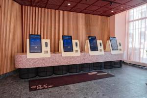 a counter with a row of computer monitors on it at Citybox Oslo in Oslo