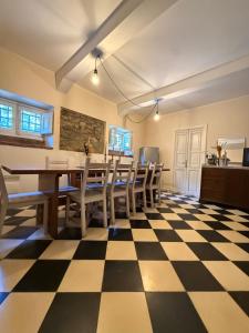 a dining room with a table and chairs on a checkered floor at La Roccia in Reggio di Calabria