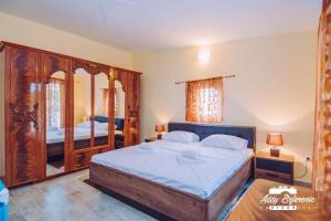 a bedroom with a large bed with a wooden frame at Penthouse S in Bar