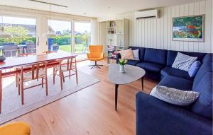 a living room with a blue couch and a table at Awesome Home In Haderslev With Wifi in Haderslev