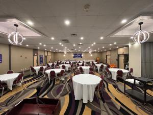 a banquet hall with white tables and chairs at Ramada by Wyndham Trenton in Trenton
