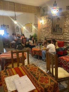 a group of people sitting at tables in a restaurant at Riad Bladi Essaouira in Essaouira +21 photos