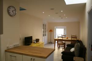 a living room with a couch and a clock on the wall at Apartment Lisa Acropolis Garibaldi in Nice