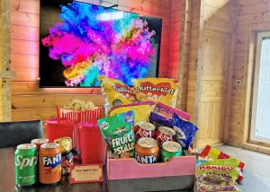 a table with snacks and popcorn and a tv at Fairview Lodges in Hollym +179 photos