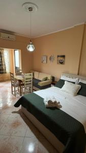 a bedroom with a large bed and a living room at Villa Gersina Golem in Golem