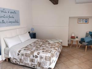 a bedroom with a bed and a blue chair at Sleep & Fly Studio Smart in Case Nuove