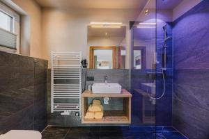 a bathroom with a sink and a shower at Alpinium - inklusive SUPER SOMMER CARD in Fiss +111 photos