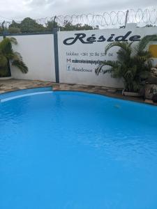 a large blue swimming pool in front of a sign at Ambourvi in Mahajanga