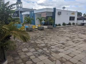 a patio with chairs and a building with a clock at Ambourvi in Mahajanga
