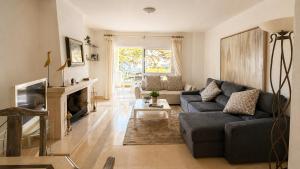 a living room with a couch and a fireplace at Troia Apartments in Troia