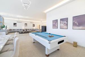 a living room with a pool table in it at Best chalet 4 BHK for group gatherings with beach access and private pool in Fujairah
