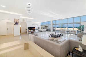 a large living room with a couch and a table at Best chalet 4 BHK for group gatherings with beach access and private pool in Fujairah
