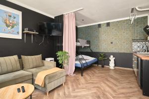 a living room with a couch and a table at Apartament Gold 4 in Złotoryja