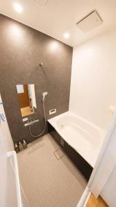 a bathroom with a shower and a tub and a sink at 姫路駅から徒歩4分 最大13名に貸し切り一軒家 先姫亭 in Himeji +17 photos