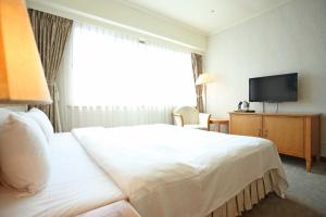 Ένα ή περισσότερα κρεβάτια σε δωμάτιο στο The Koos Hotel