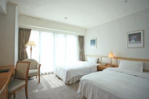 Ένα ή περισσότερα κρεβάτια σε δωμάτιο στο The Koos Hotel