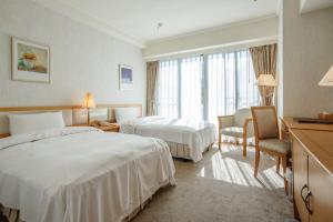 Postel nebo postele na pokoji v ubytování The Koos Hotel