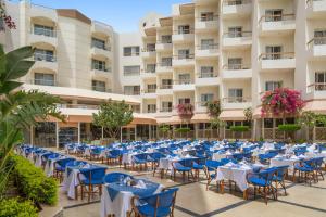 a group of tables and chairs in front of a building at Seagull Beach Resort - Families and Couples Only in Hurghada