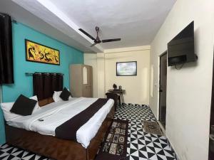 a bedroom with a large bed and a flat screen tv at Hotel South embassy near Durgabai dekhmukh metro in New Delhi