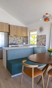a kitchen with a table and a table and chairs at Trentham Waters Resort in Gol Gol
