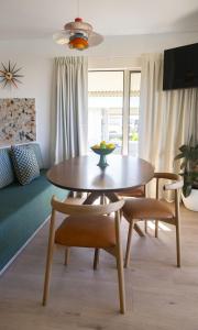 a table and chairs in a living room with a table at Trentham Waters Resort in Gol Gol