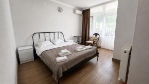 a bedroom with a bed with towels on it at Villa TG for Large Families with Private Pool in Batumi +42 photos