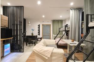a living room with a couch and a bed and a table at Apartament Gold 3 in Złotoryja