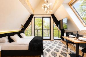 a living room with a white couch and a table at Tatry Residence SPA in Kościelisko