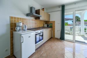 a kitchen with a refrigerator and a stove at Apartments Anka in Krk +24 photos