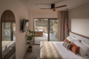 a bedroom with a bed and a sliding glass door at Enorme Infinity Beach ex Infinity Blue in Hersonissos